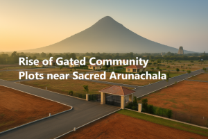 A panoramic view of a modern gated community near Arunachala Hill in Tiruvannamalai, with sunrise light bathing the sacred mountain and multiple villa plots outlined in green space. Overlaid text reads “Rise of Gated Community Plots near Sacred Arunachala,” highlighting the blend of spiritual serenity and planned development.