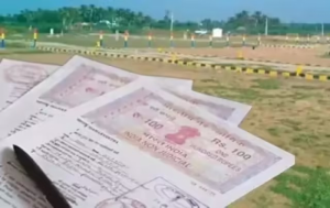 Three land-related documents featuring Rs. 100 Indian non-judicial stamp papers, placed outdoors against a backdrop of greenery, roadside barriers, and asphalt—suggesting legal verification tied to property or land records in Tamil Nadu.
